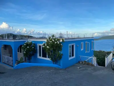 a blue house with a view of the water at Top of the Hill Blue Sunshine in Long Swamp