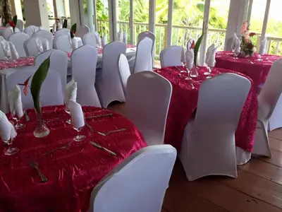 a row of tables and chairs with red and white table cloth at Fort Burt Hotel in Road Town