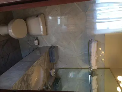 a bathroom with a tub and a sink and a window at Fort Burt Hotel in Road Town