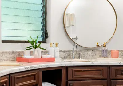 a bathroom with a sink and a mirror at On The Rocks Villa in Spanish Town