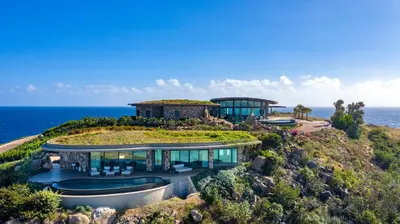 an image of a house on a hill overlooking the ocean at Oil Nut Bay in Virgin Gorda