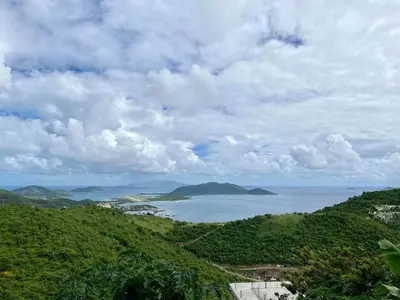 a view of the ocean from a hill at Ocean Breeze Comfort in East End