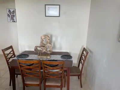 a dining room table with a sculpture on top of it at Ocean Breeze Comfort in East End