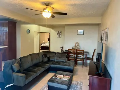 a living room with a couch and a dining room at Ocean Breeze Comfort in East End
