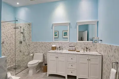 a bathroom with a toilet and a sink and a shower at Cane Garden Bay Beach Hotel in Cane Garden Bay