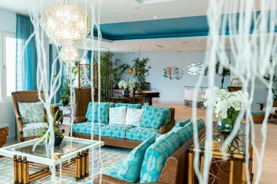 a living room with a couch and a table at Cane Garden Bay Beach Hotel in Cane Garden Bay