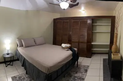 a bedroom with a bed and a ceiling fan at JYM Blissful Escape in Tortola Island