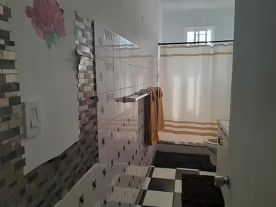 a bathroom with a tiled floor and a toilet at Abigail Diamond 2 bedroom apt Near Nanny Cay marina in Hannah