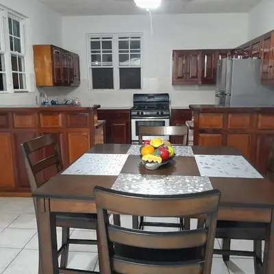 a kitchen with a table with a bowl of fruit on it at Abigail Diamond 2 bedroom apt Near Nanny Cay marina in Hannah