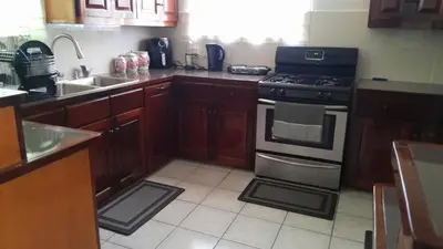 a kitchen with a stove and a sink at Abigail Diamond 2 bedroom apt Near Nanny Cay marina in Hannah