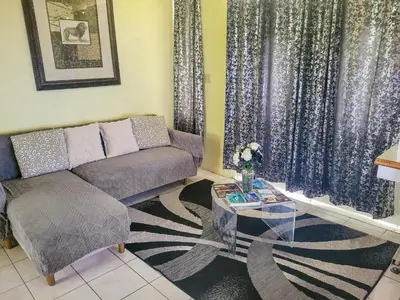 a living room with a couch and a table at Sailor's Gem in Tortola Island