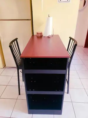 a desk with two chairs and a lamp on top at Sailor's Gem in Tortola Island