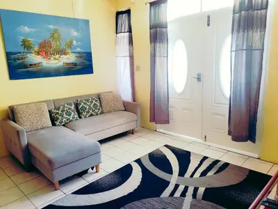 a living room with a couch and a chair at Sailor's Gem in Tortola Island