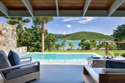 a swimming pool in a villa with a view of the ocean at Rosewood Little Dix Bay in Virgin Gorda Airport
