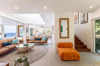 a living room with a couch and a table at Cannon Point Estate in Cane Garden Bay