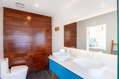 a bathroom with two sinks and a mirror at Cannon Point Estate in Cane Garden Bay