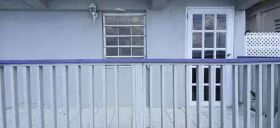a white fence in front of a house at Beach Front Haven, by More Than Beauty Properties in Tortola Island