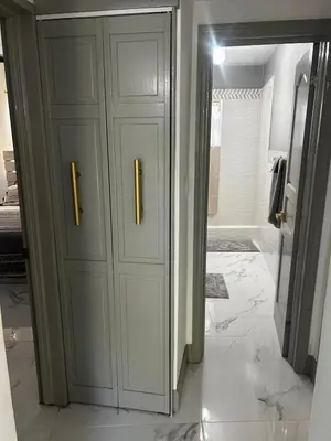 a bathroom with a white cabinet with two handles at Cane Garden Bay 2 bed Apt in Leonards