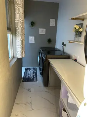 a small kitchen with a stove and a tile floor at Cane Garden Bay 2 bed Apt in Leonards