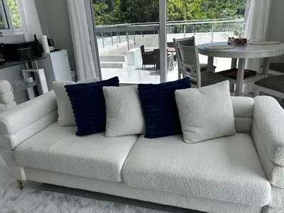 a white couch with blue pillows in a living room at Zafira Luxe in Road Town