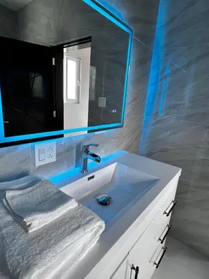 a bathroom with a white sink and a mirror at Zafira Luxe in Road Town