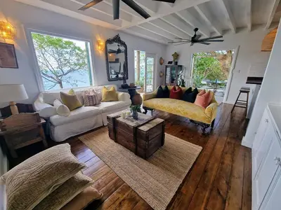 a living room with a couch and a table at Lowena Cottage in Tortola Island