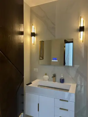 a bathroom with a white sink and a mirror at Zafira Luxe in Leonards