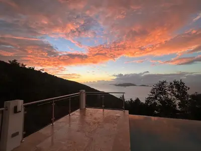 a view of the sunset from the balcony of a house at Zafira Luxe in Leonards
