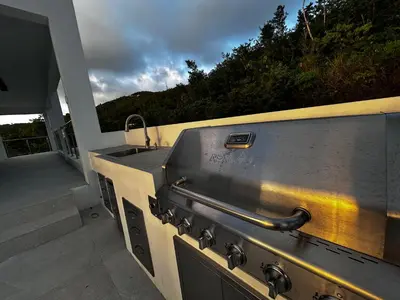 a outdoor grill with a sink on a patio at Zafira Luxe in Leonards