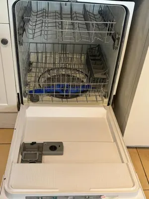 an empty dishwasher with a dish rack in it at BluEdge Villa VIP Resort Access in Tortola Island