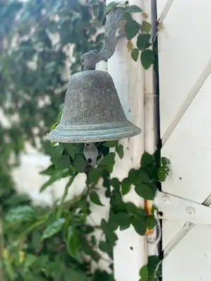an old bell hanging on the side of a building at Endless Summer Villa in Tortola Island