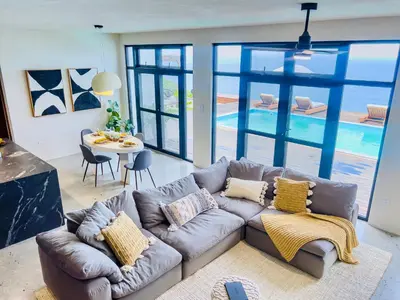 a living room with a couch and a table at Villa Odyssea BVI in Tortola Island