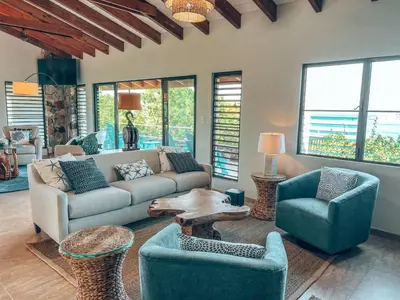 a living room with a couch and two chairs and a table at Tamarind Villa in Virgin Gorda