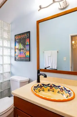 a bathroom with a sink and a mirror at Tamarind Villa in Virgin Gorda