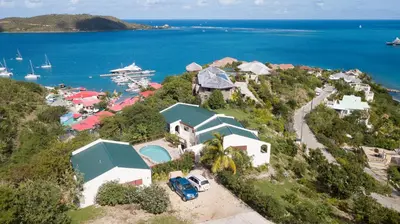 an aerial view of a house on a hill next to the ocean at Tamarind Villa in Virgin Gorda