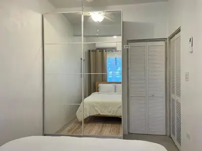 a mirror in a room with a bed and a bedroom at Abigail's Sunlit Nook in Tortola Island