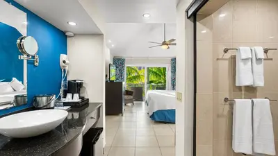 a bathroom with a sink and a bed in a room at Moorings Yacht Club in Road Town
