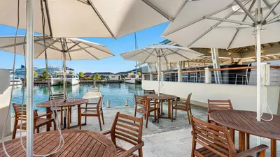 a restaurant with tables and chairs and umbrellas at Moorings Yacht Club in Road Town