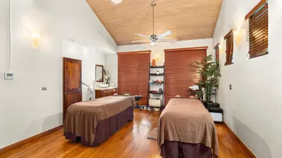 two beds in a room with wooden floors at Moorings Yacht Club in Road Town