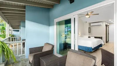 a bedroom with a bed and a balcony at Moorings Yacht Club in Road Town