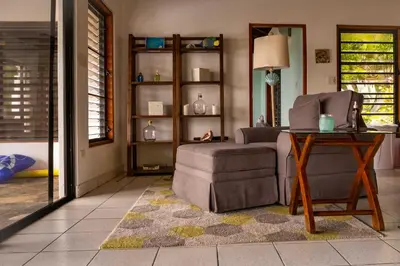 a living room with a couch and a chair and a table at Villa ValMarc Mahoe Bay Virgin Gorda BVI in Virgin Gorda
