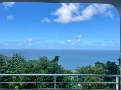 a view of the ocean from a balcony at Abigail's Esmeralda 2 bedrom Apt in Tortola Island