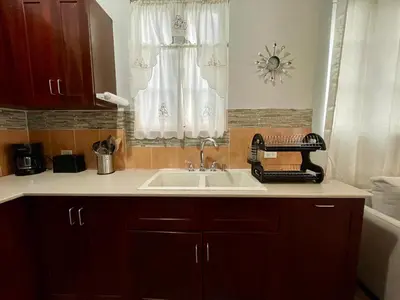 a kitchen counter with a sink and a window at Abigail's Esmeralda 2 bedrom Apt in Tortola Island