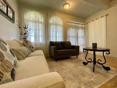 a living room with a couch and a table at Abigail's Esmeralda 2 bedrom Apt in Tortola Island