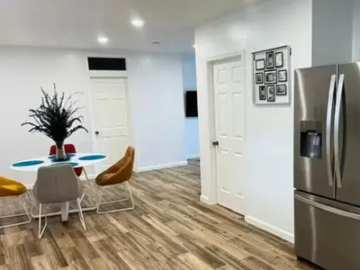a kitchen and dining room with a table and a refrigerator at Amazing place on BVI in Road Town