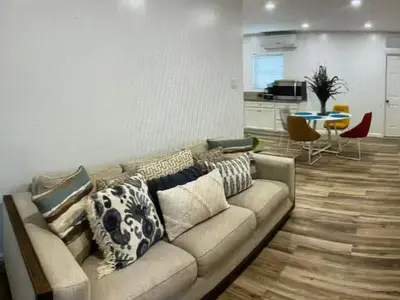 a living room with a couch and a kitchen at Amazing place on BVI in Road Town