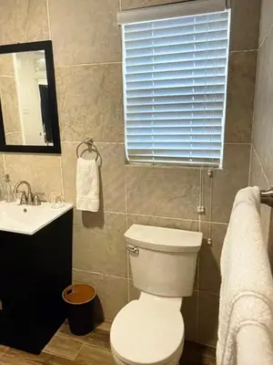 a bathroom with a toilet and a sink and a window at Amazing place on BVI in Road Town