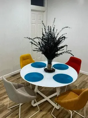 a table with chairs and a vase with a plant on it at Amazing place on BVI in Road Town