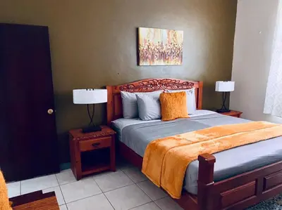 a bedroom with a bed with two lamps on a table at Tranquil Escape at Ballast Bay in Road Town