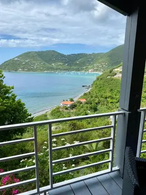 a balcony with a view of a beach at Tranquil Escape at Ballast Bay in Road Town